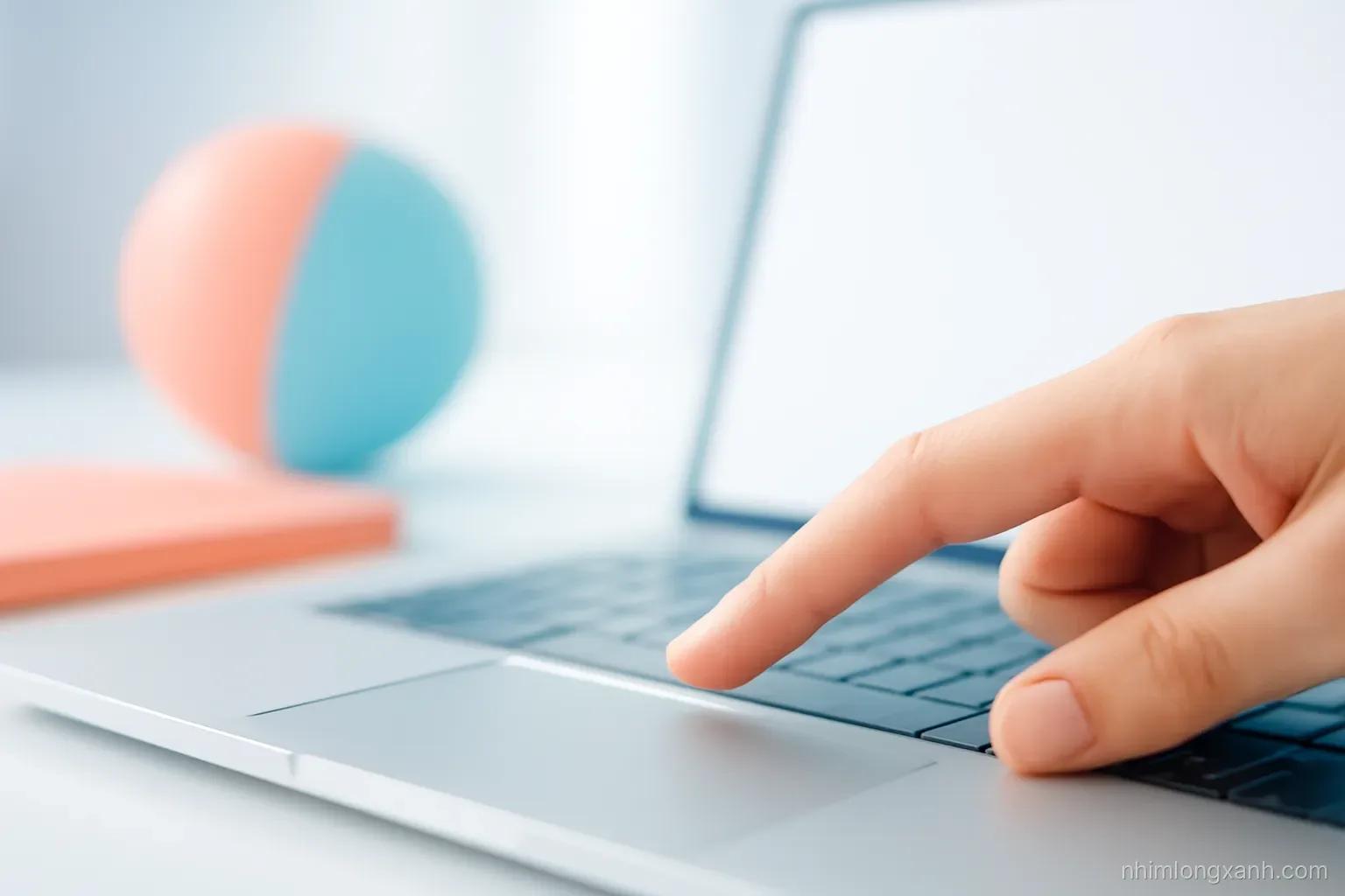 Close-up macro of a fingertip about to press a keyboard key, laptop with blank bright screen softly blurred behind, clean white desk, pastel coral and sky blue accents, shallow depth of field
