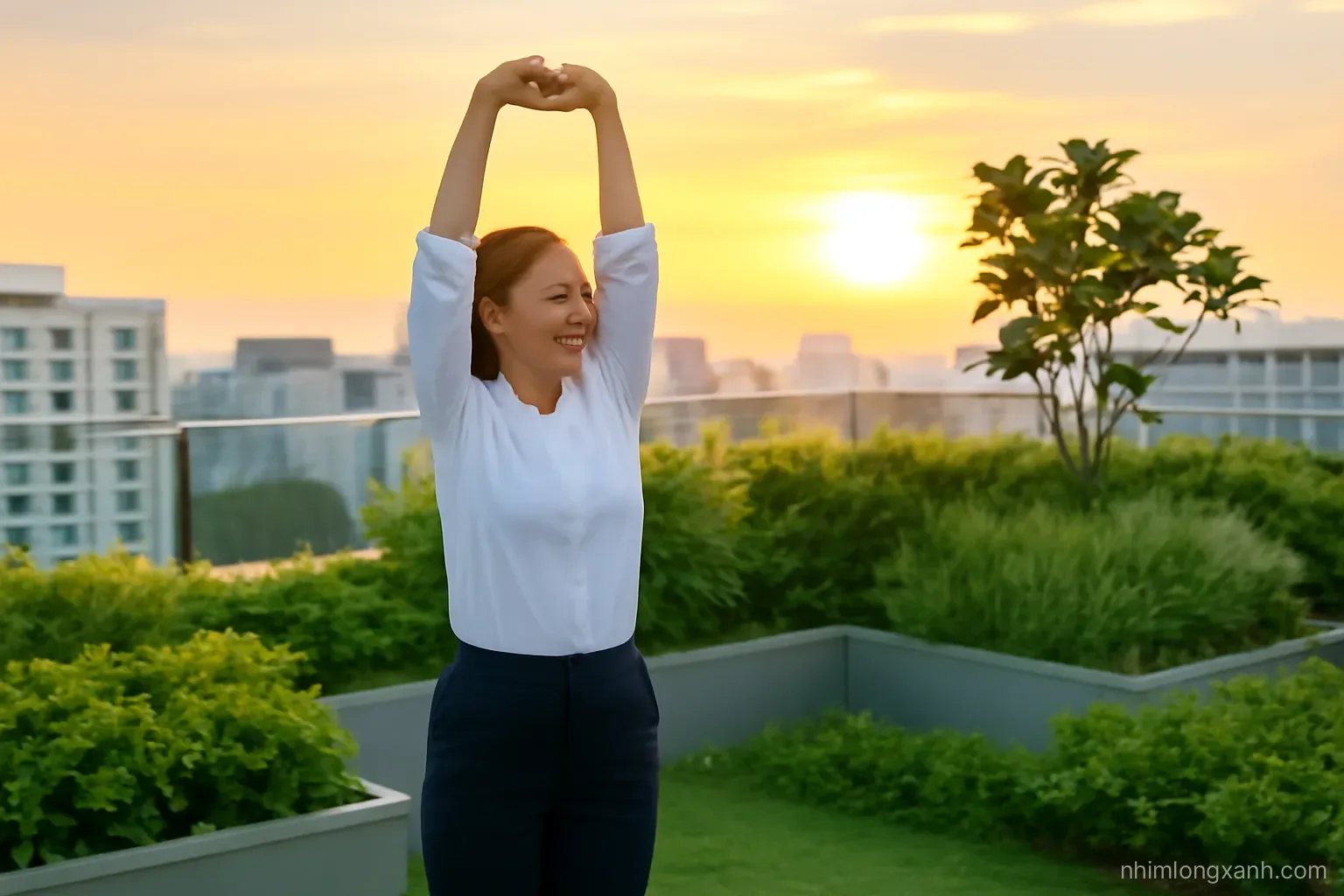 Wide shot of a Vietnamese office worker in her forties doing slow stretching on a green rooftop garden at sunset, eyes closed, warm orange sky, relaxed posture