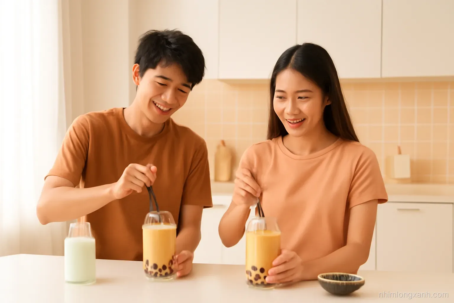 Wide shot of two Vietnamese teenagers shaking milk tea with tapioca pearls in a bright modern home kitchen, glass cups, natural daylight, peach and caramel color palette