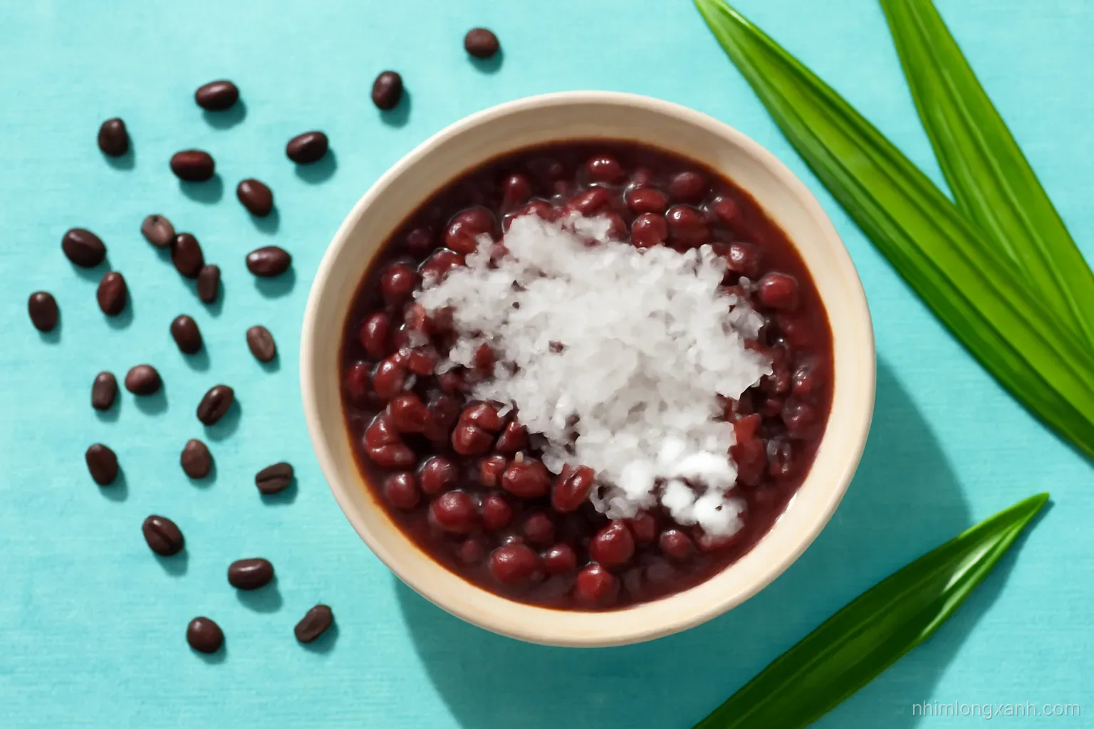 Overhead flat lay of a ceramic bowl of sweet black bean soup with crushed ice and coconut cream, scattered dried beans and pandan leaves, cool turquoise tablecloth, bright daylight