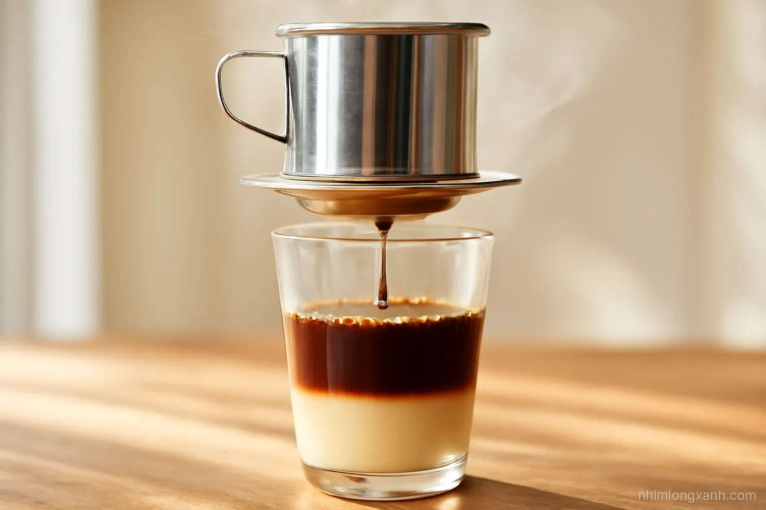 Extreme close-up of dark coffee dripping from a metal phin filter into a glass with condensed milk, morning sunlight through steam, warm brown and cream tones, wooden table
