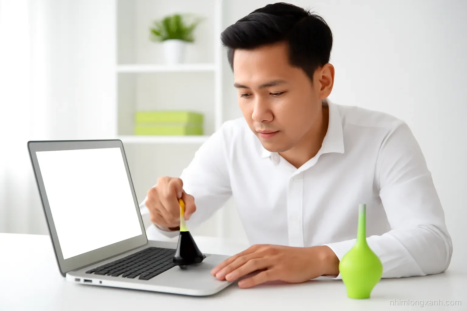 Eye-level medium shot of a Vietnamese man cleaning laptop vents with a soft brush at a bright tidy workbench, laptop open with blank glowing screen, air blower nearby, crisp daylight, white and lime palette