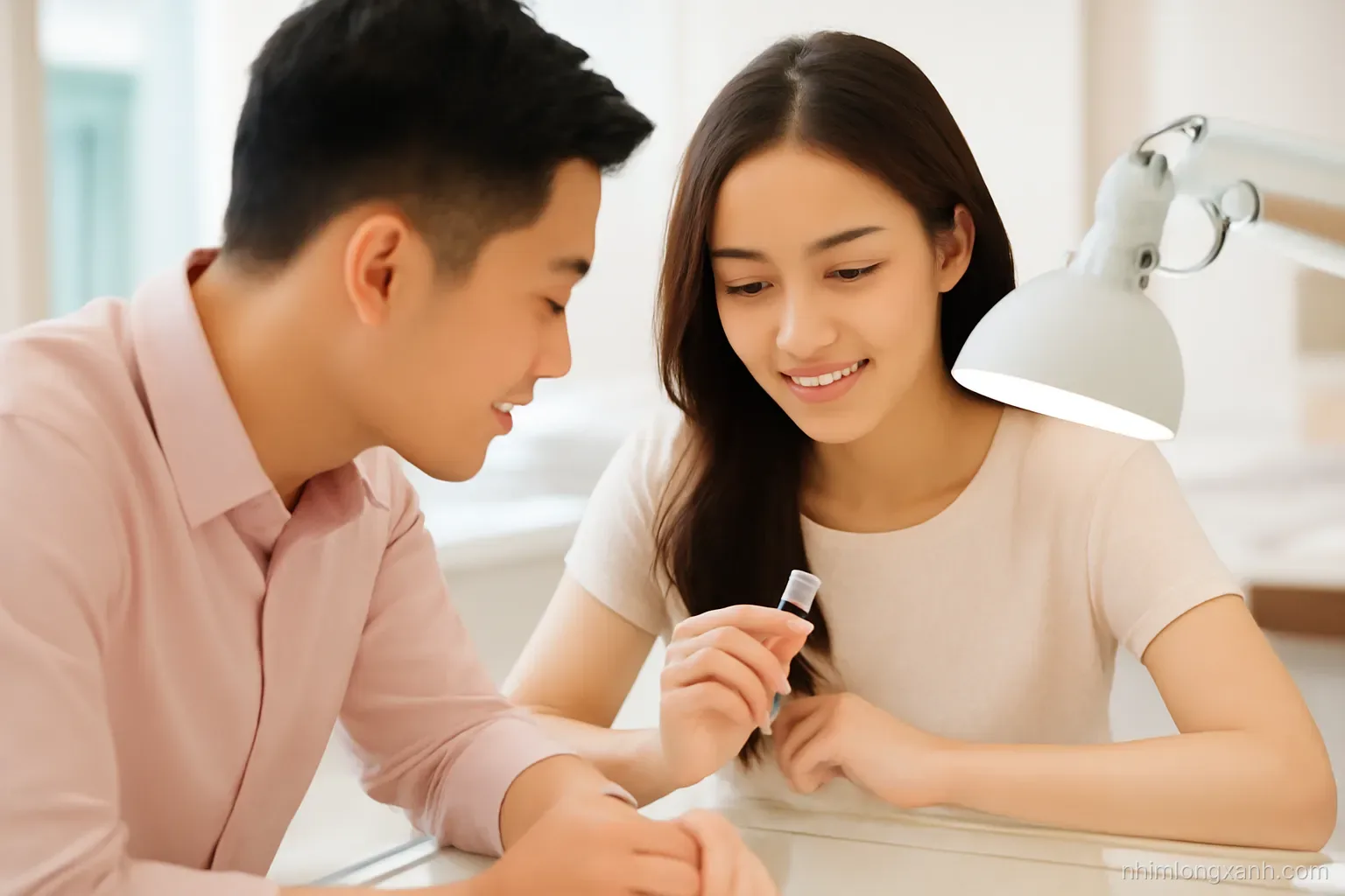 Over-the-shoulder view of a Vietnamese couple at a glass counter studying a loose round diamond under a jeweller's lamp, soft blush and ivory tones, shallow depth of field