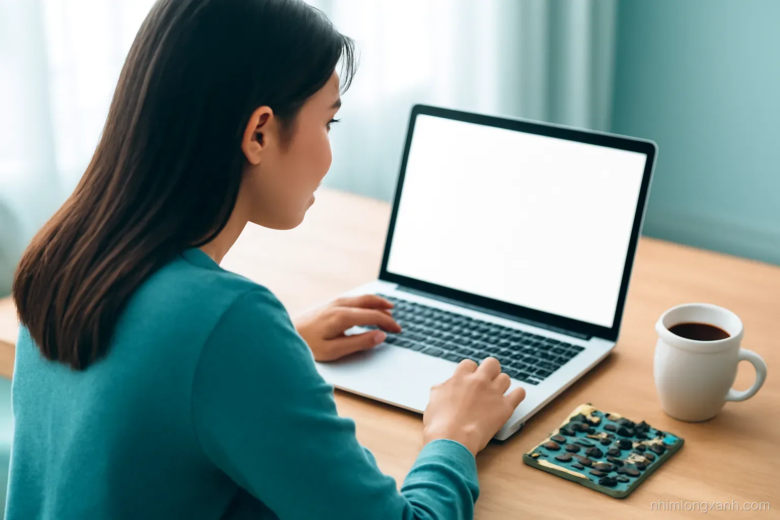 Over-the-shoulder view of a young Vietnamese engineering student at a wooden desk, laptop with blank glowing screen, circuit board and coffee cup nearby, soft morning light, teal and white tones