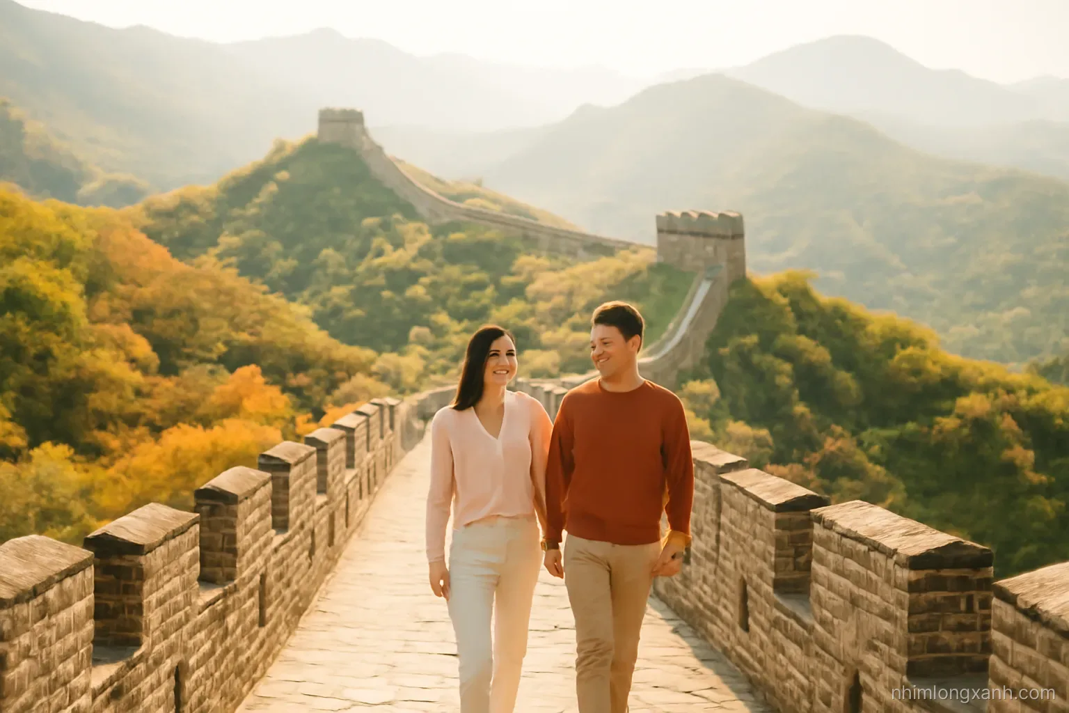 Ancient stone wall snaking over green mountain ridges in autumn, watchtowers fading into soft haze, a young Vietnamese couple walking on the rampart, high angle view, warm golden and green tones